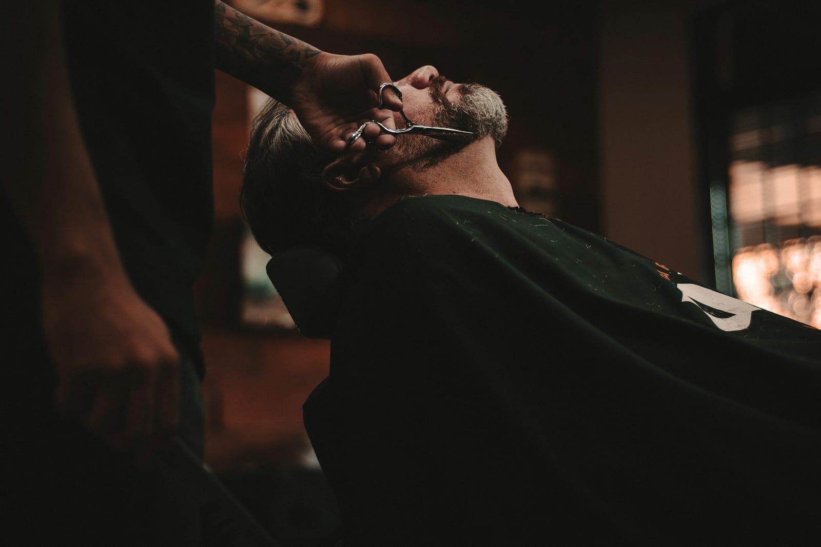 Barber trimming a beard for a clean lineup