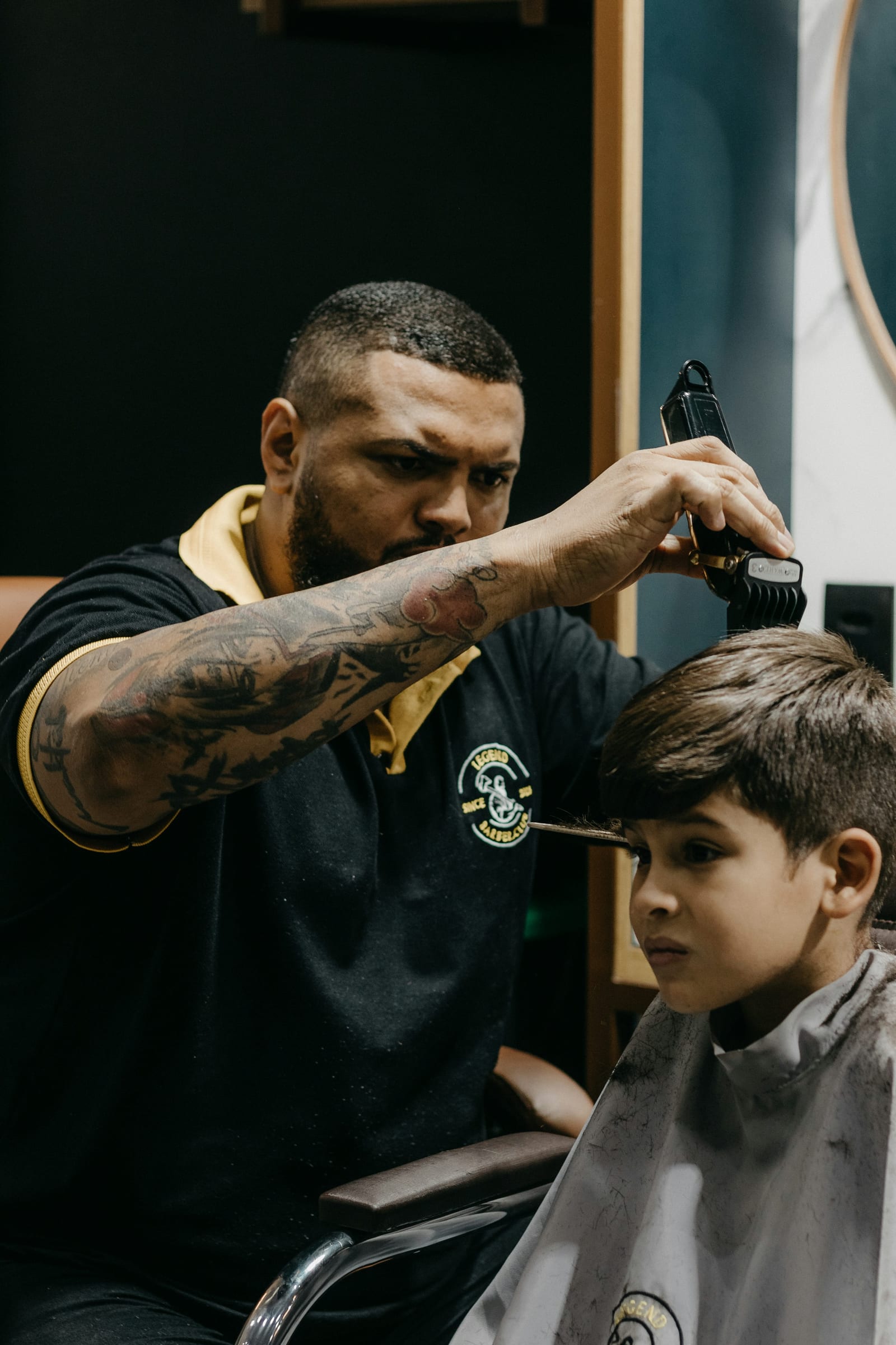 Young boy getting a haircut in a barbershop