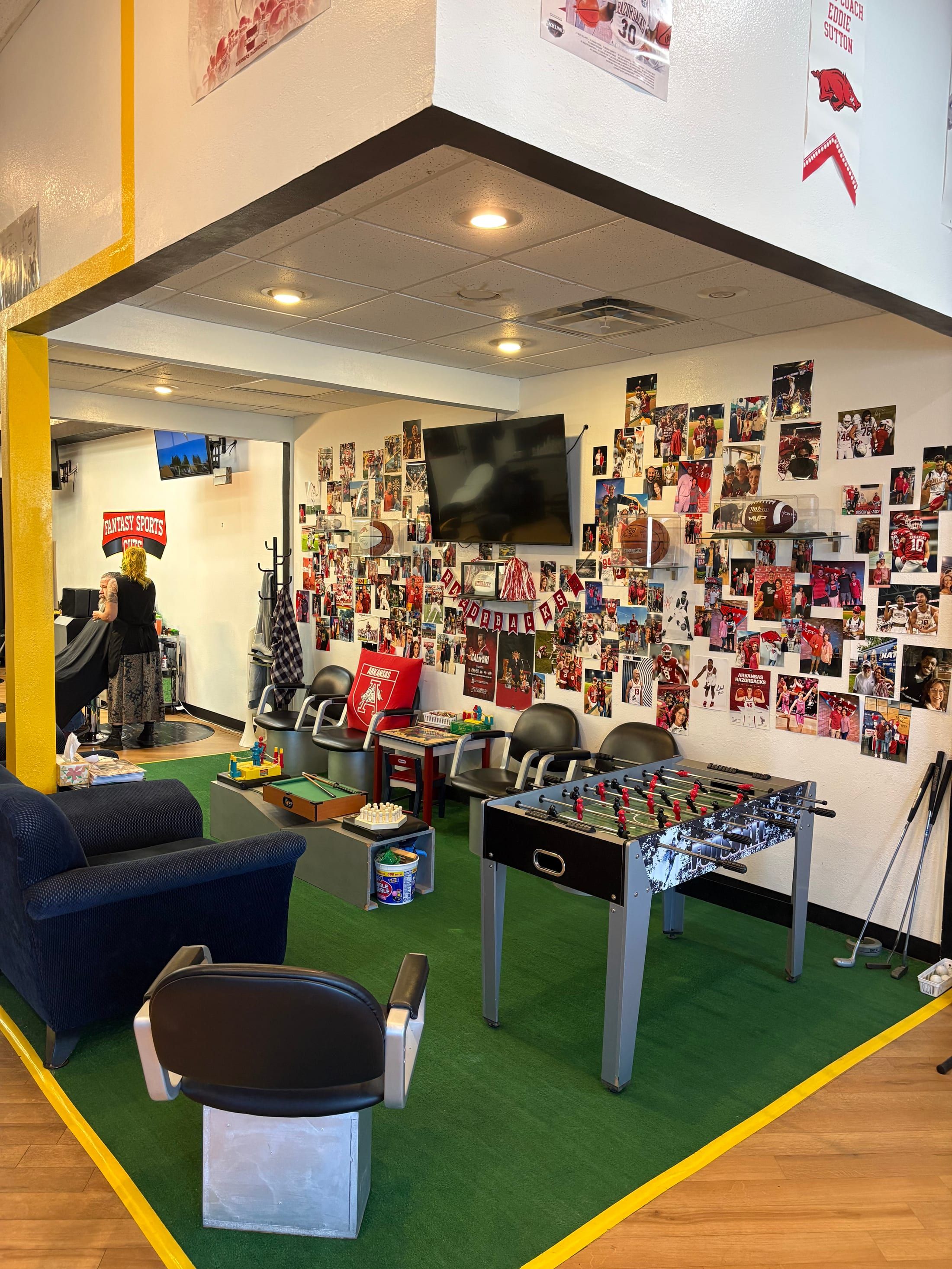 Fantasy Sports Cuts sports lounge with seating, foosball, games, TV, and Razorbacks wall in Fayetteville AR